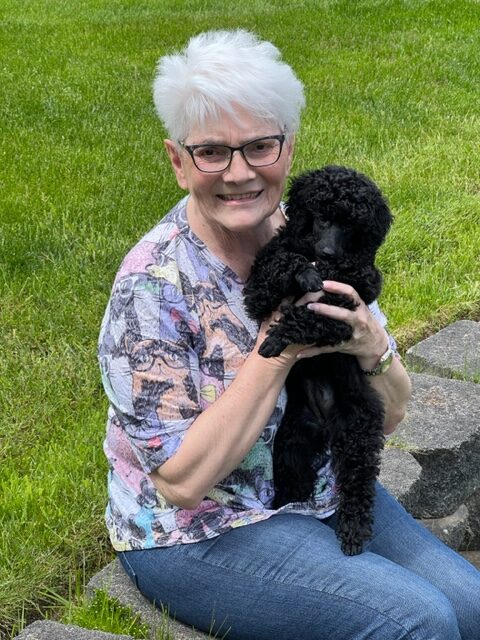 Happy puppy parent with their new Poodle